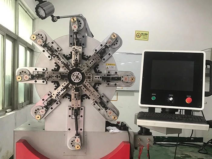 How to adjust the position of wire feeding wheel of multi axis spring machine?